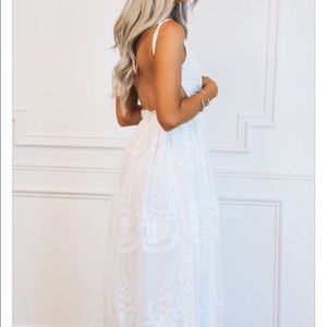 Floor length white lace dress.